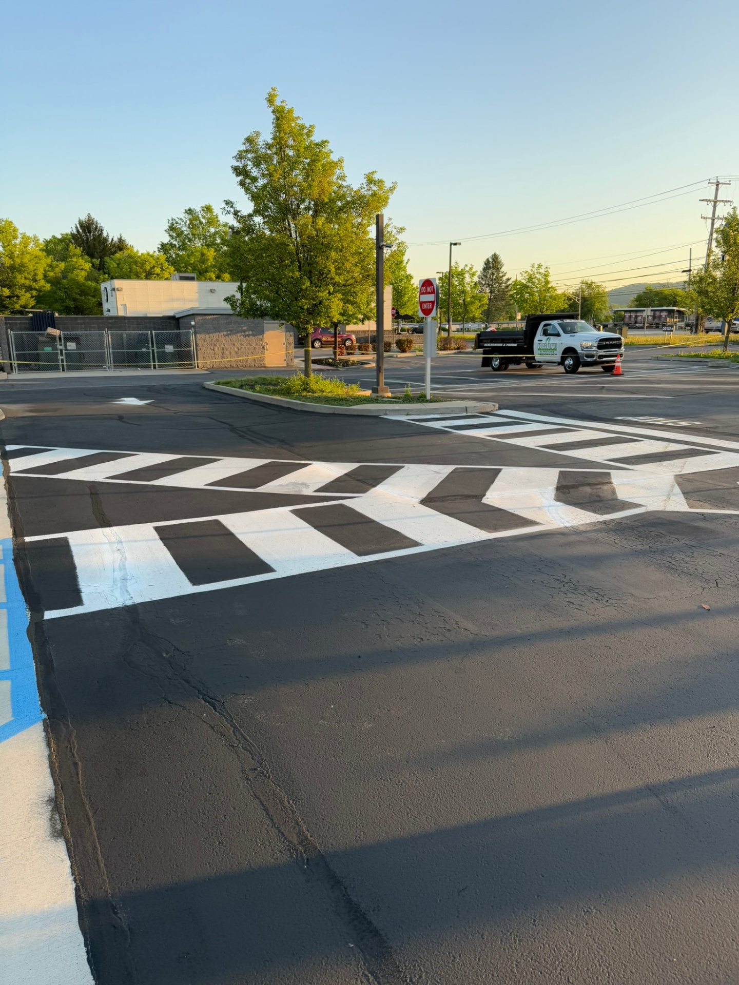 Fresh white line striping and crosshatch on a sealcoated commercial lot