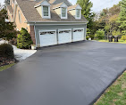 Sealcoated driveway leading to three-car garage