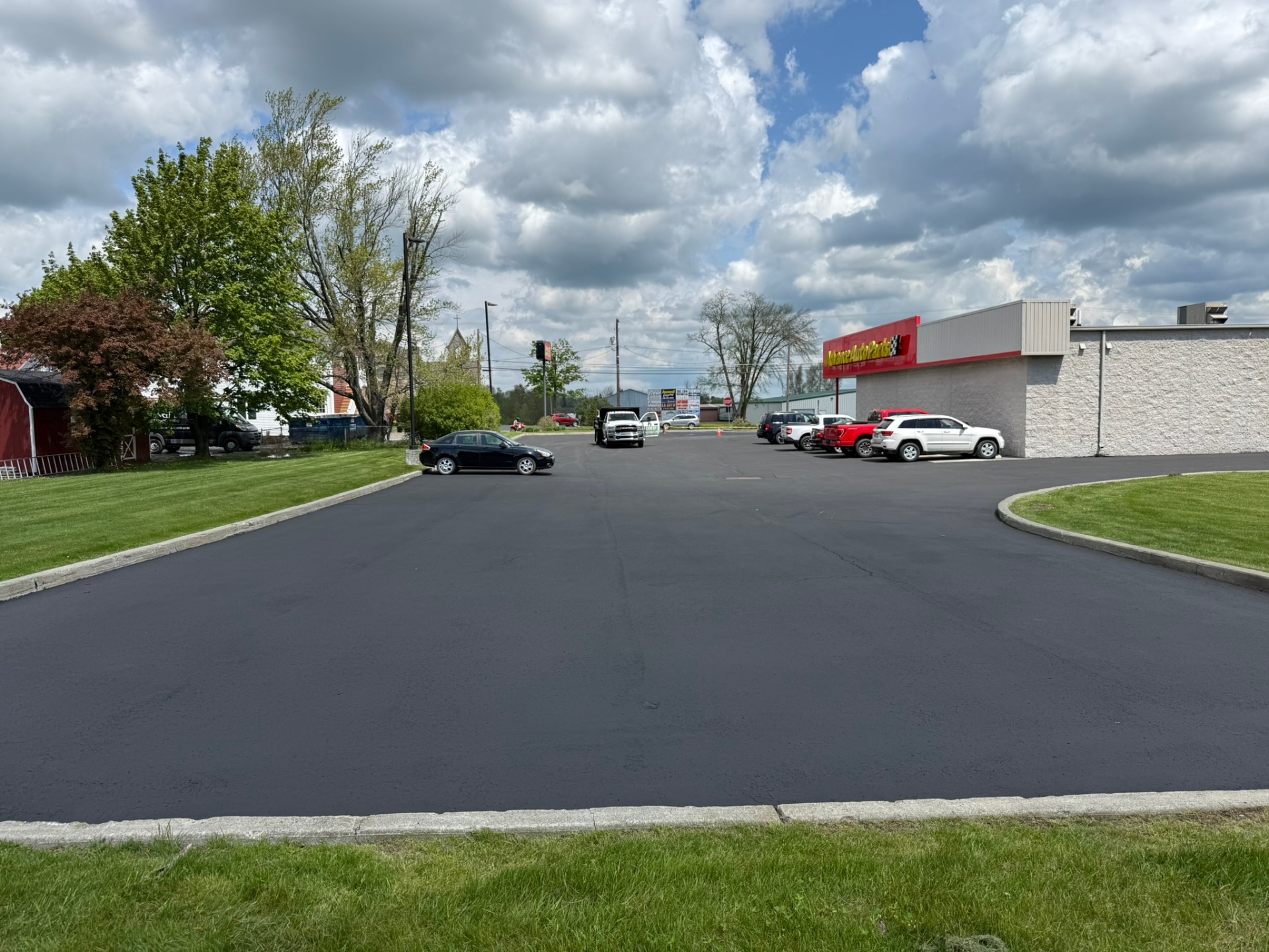 Freshly sealcoated commercial parking lot with clean curb lines