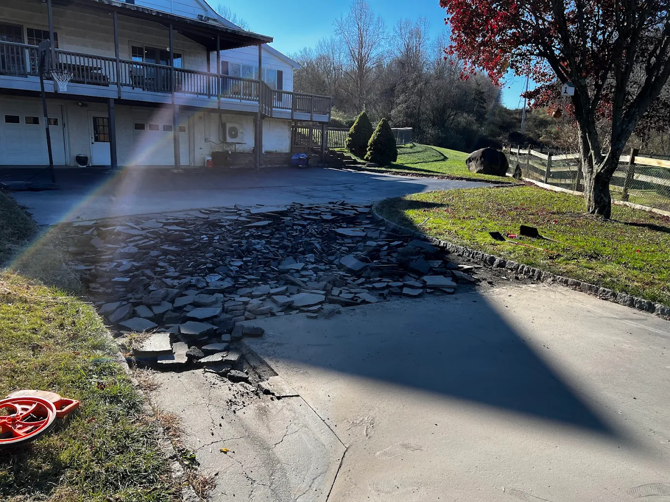 Old asphalt driveway broken up for removal and repaving