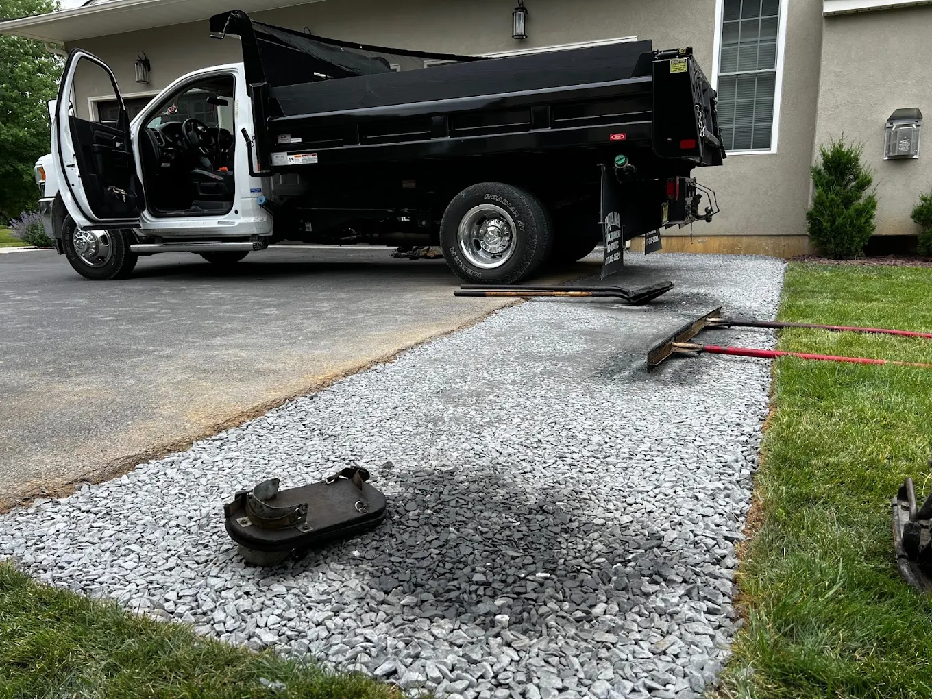 New gravel base and dump truck prepping driveway install